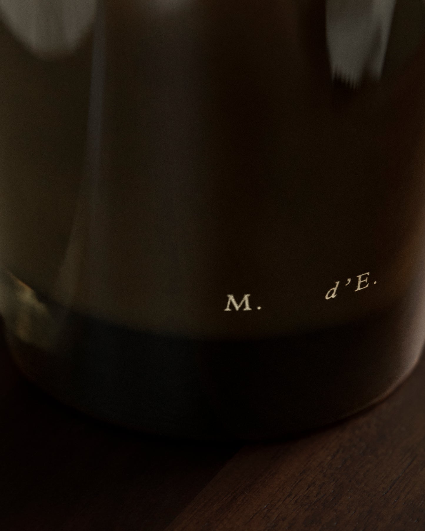 Dark brown ceramic coffee mug with m logo featured with maison detto candle rotano product set