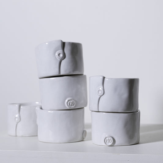 Gray ceramic ring holders with subtle button detail and embossed md logo from birch ramekins no 241 collection