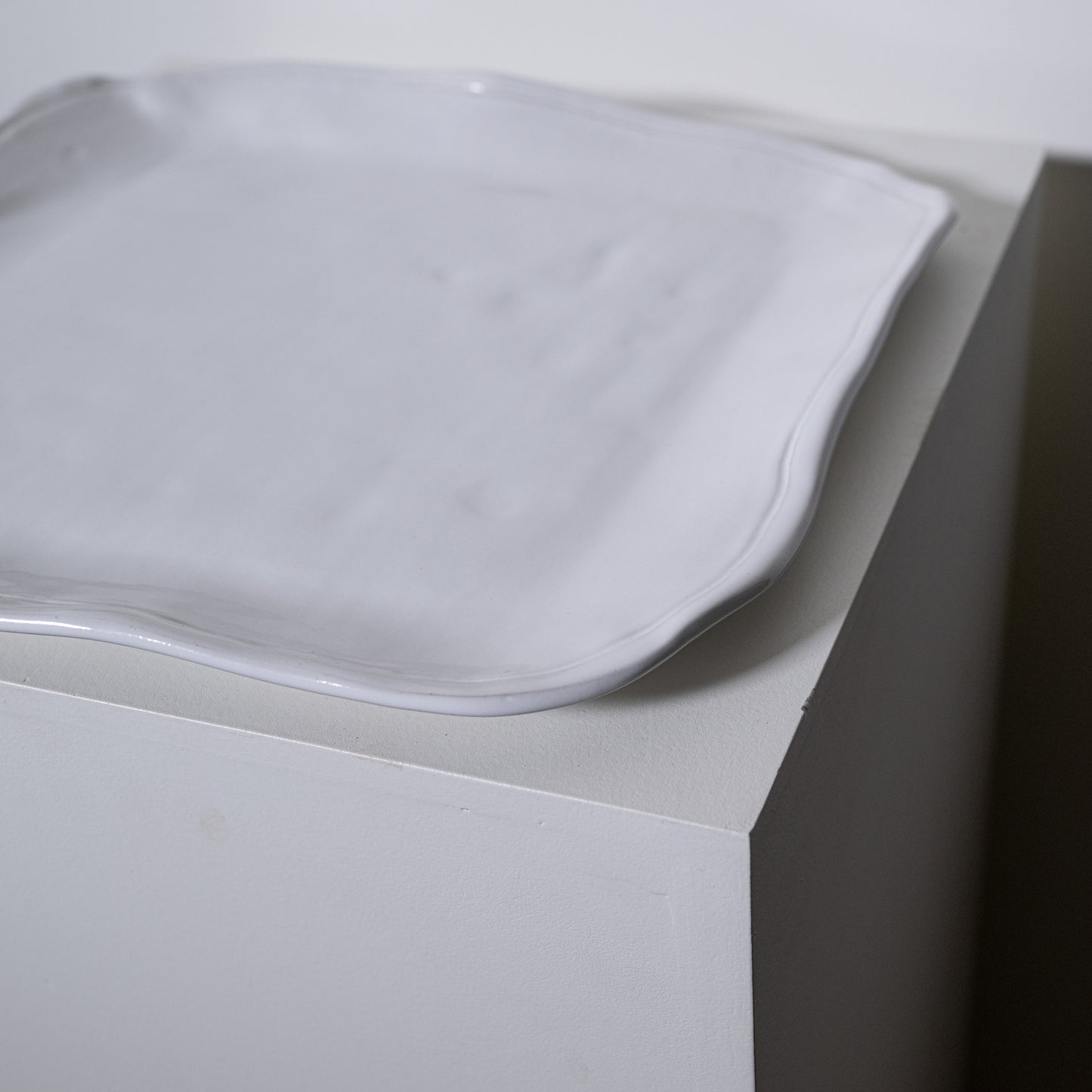 A matte white ceramic serving tray with softly curved irregular edges called boxwood platter no 227