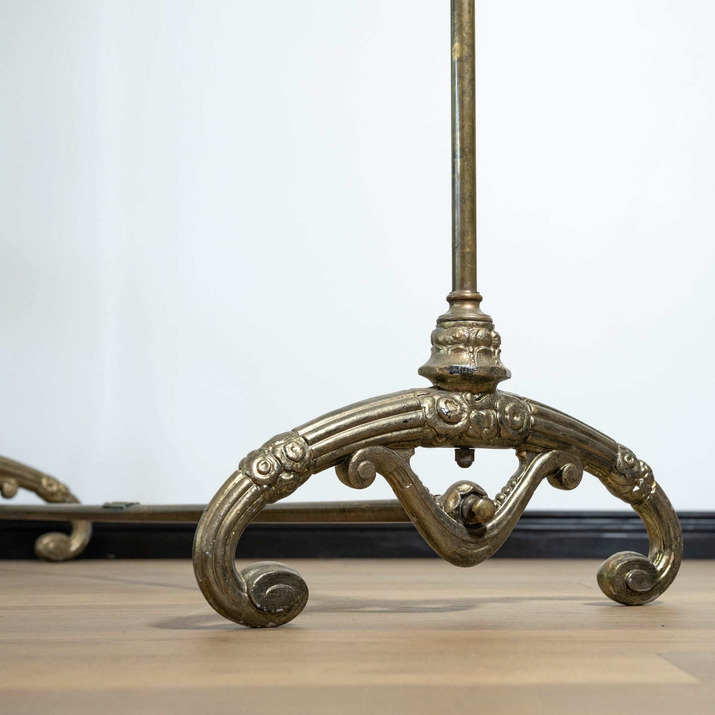 Decorative metal rack with intricate designs on a light background