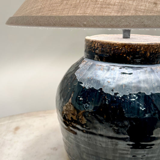 Mid century Shanxi glazed pot table lamp with a dark blue ceramic base textured glazed finish and rustic brown rim
