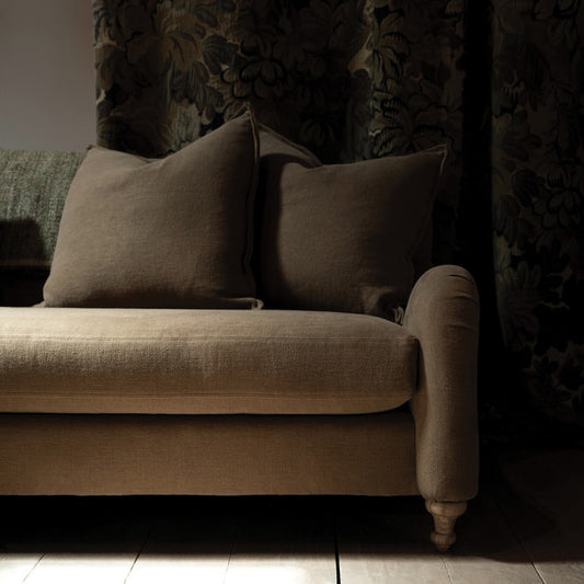 Beige linen custom order margot sofa with rolled arms wooden legs and two matching throw pillows