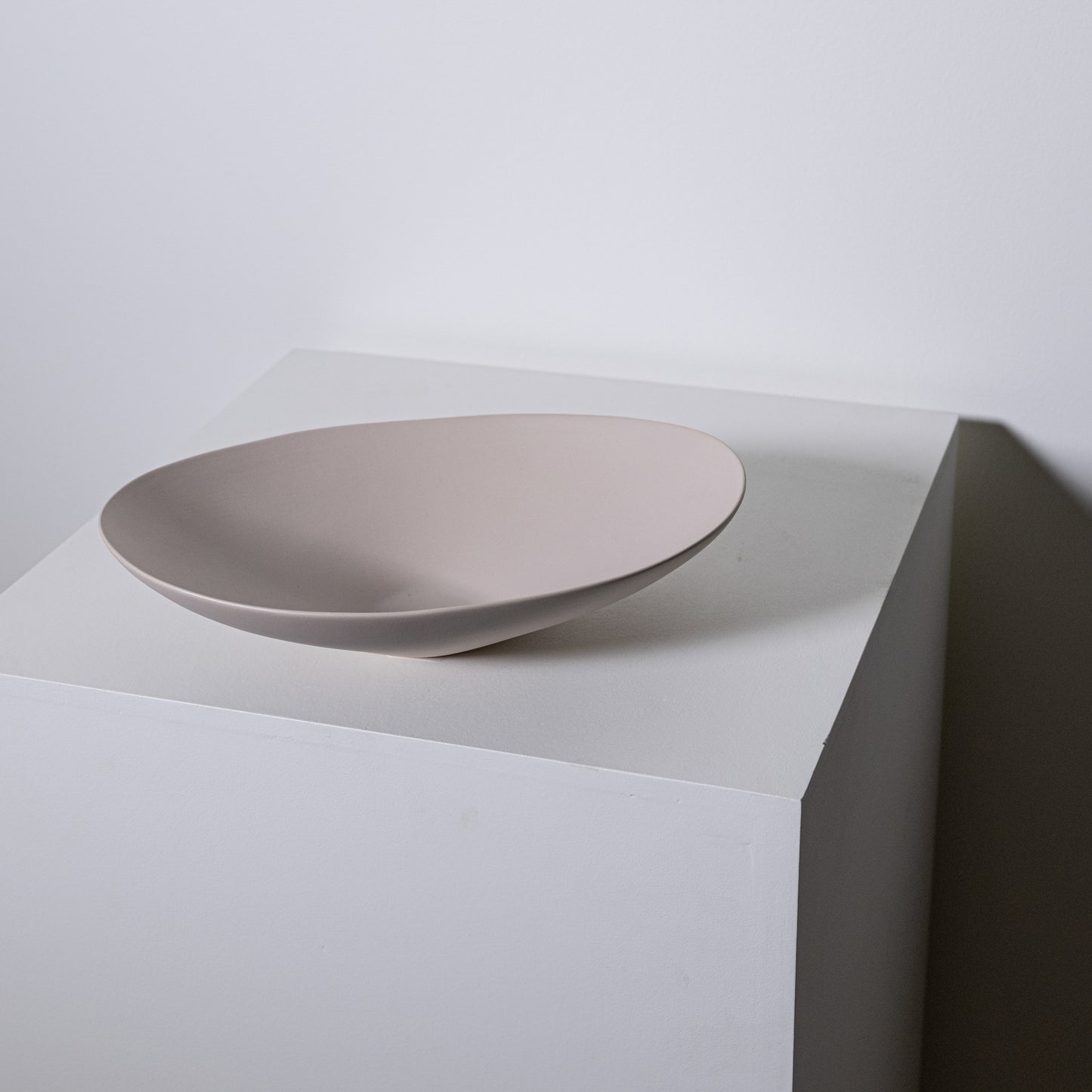 A sleek matte-finished beige ceramic vessel sink with a modern minimalist design baccello small greige