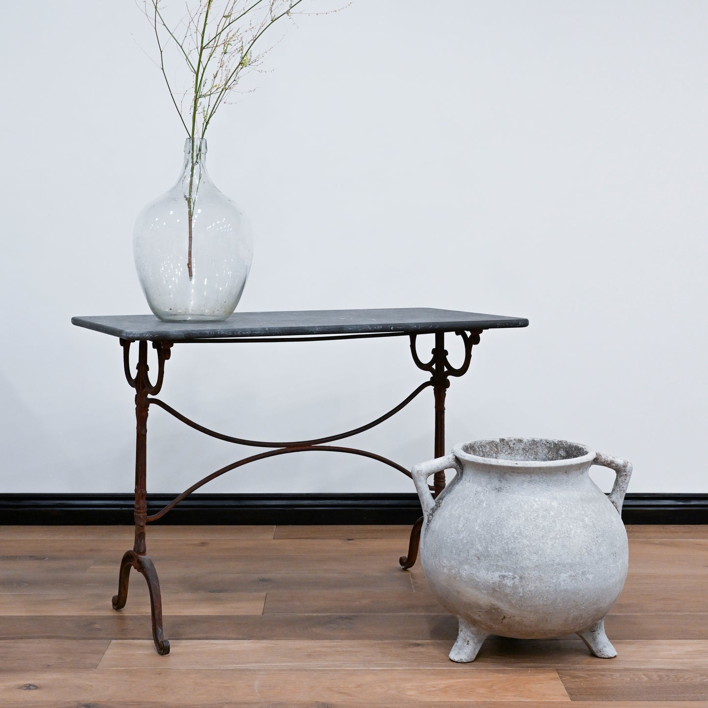 Demijohn rustic wrought iron console table with dark slate top and ornate curved legs perfect for entryways