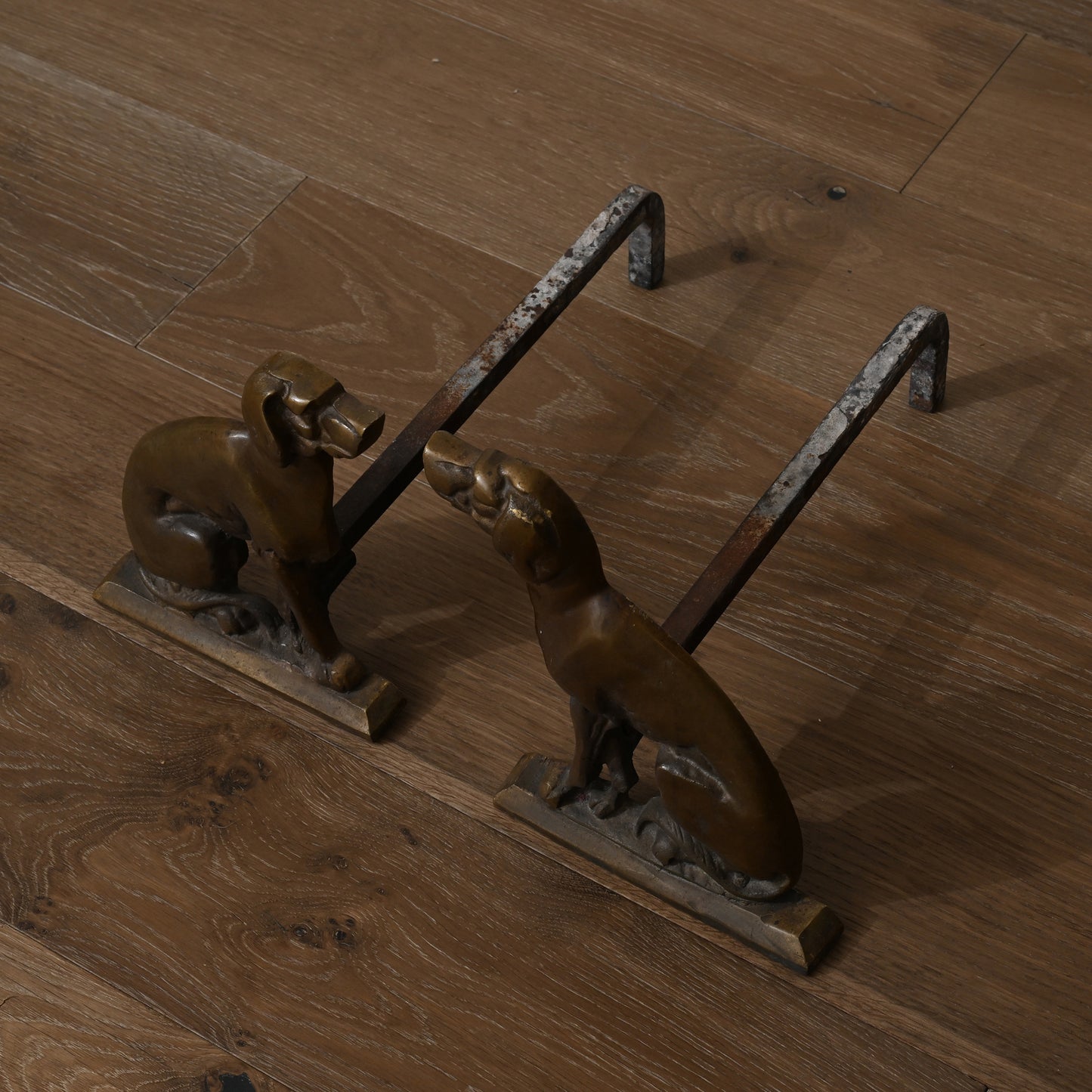 Early 20th century antique brass dog-shaped fireplace andirons with patina-finished metal handles