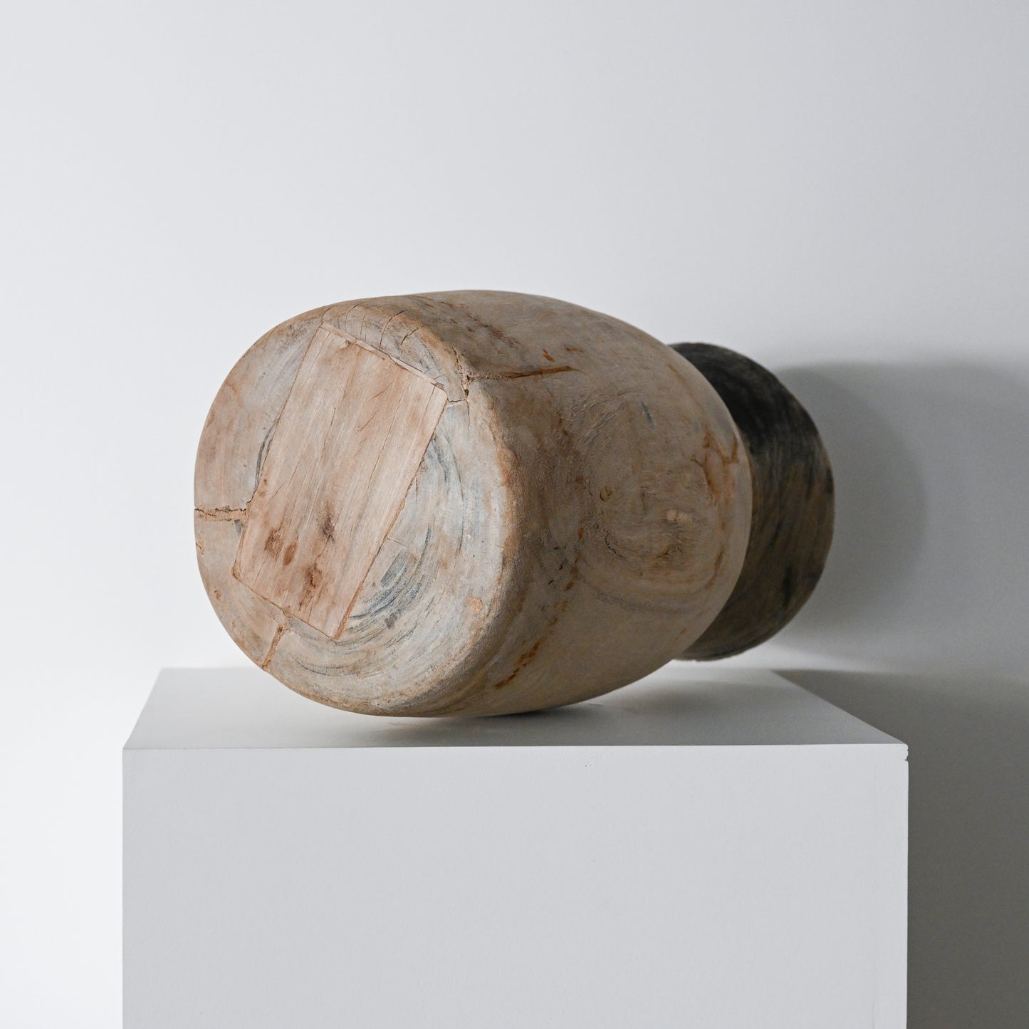 Handcrafted wooden primitive wood vessel with natural weathered finish and visible grain patterns in brown tones