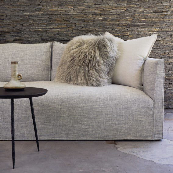 Light gray linen custom order Thibaut sofa with fluffy beige throw pillow and white cushion for cozy seating