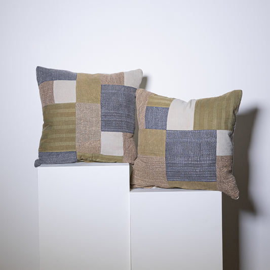 Two mosaic pillows with rectangular patchwork design in olive green beige and muted blue woven fabric