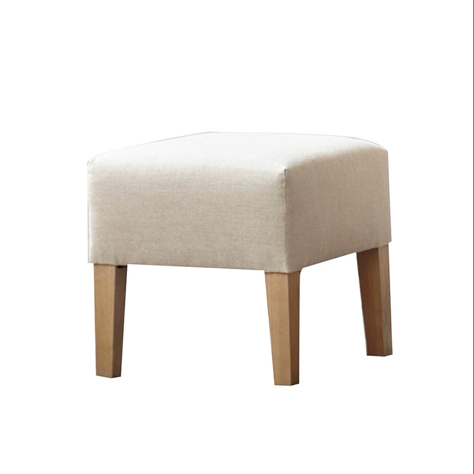 Beige upholstered custom order kim ottoman with square shape and light wood legs for versatile seating and decor