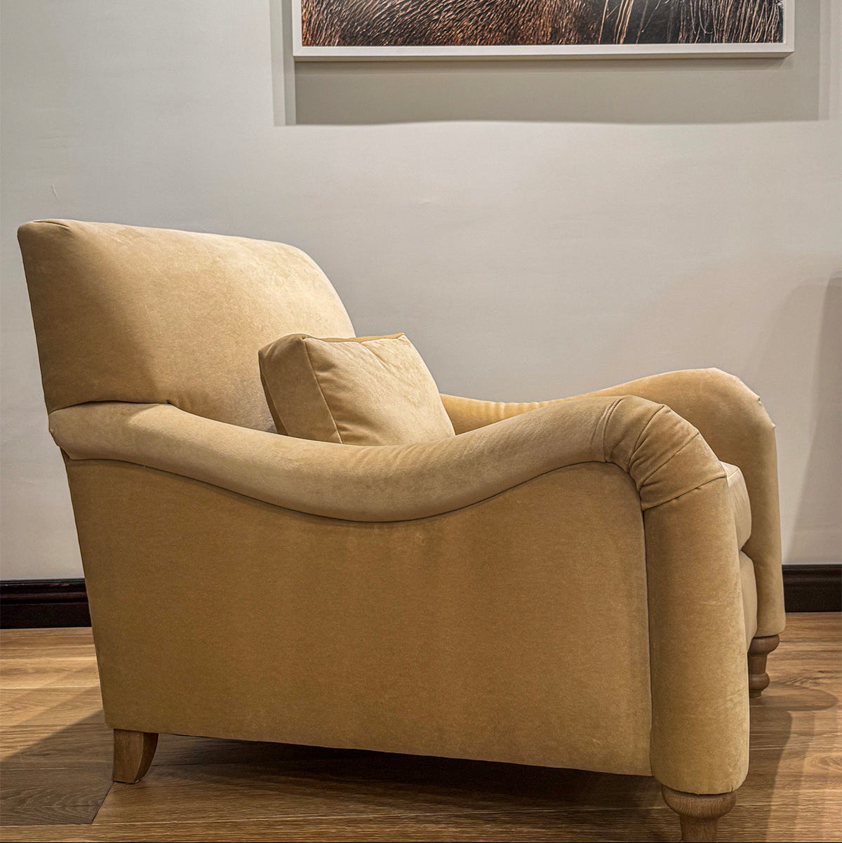 Beige velvet custom order margot club chair with rolled arms and wooden legs for comfortable seating