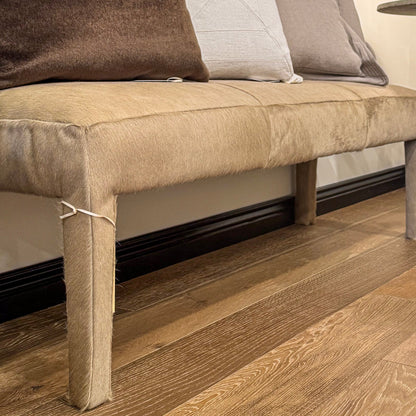 Custom order charlie bench with beige cowhide upholstery sturdy wooden legs and a cozy textured surface