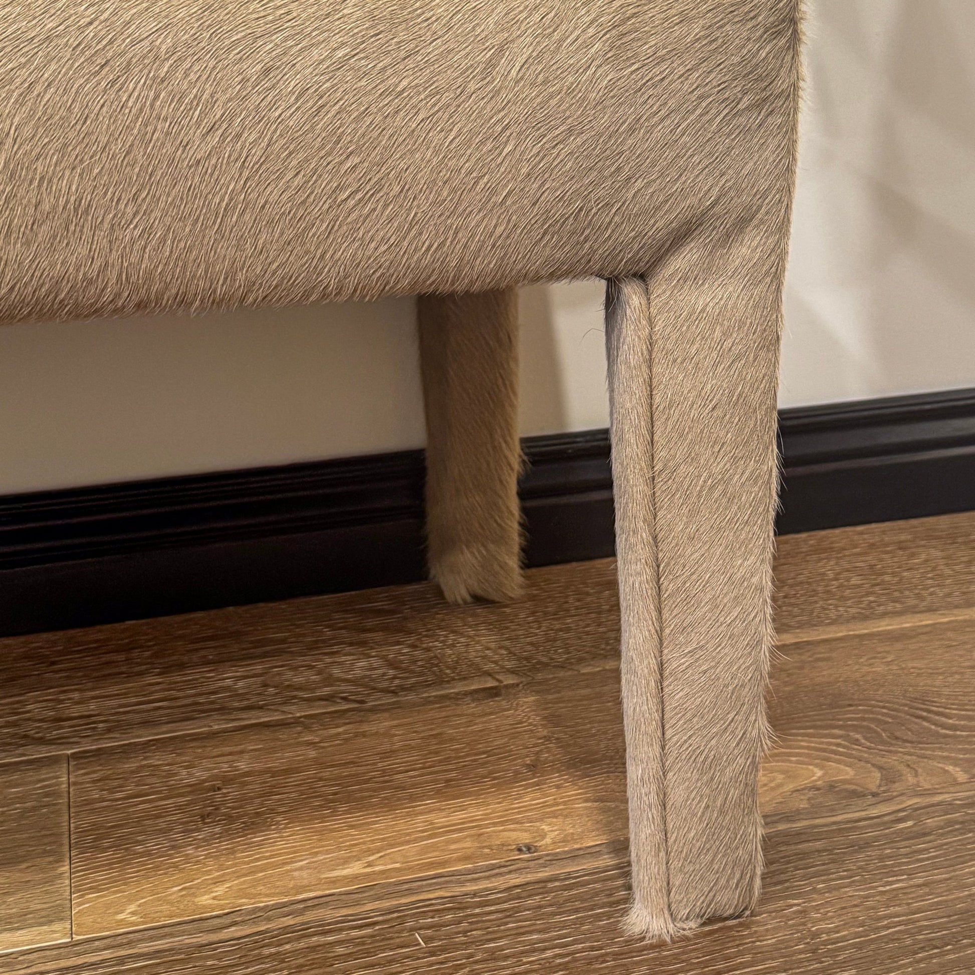 Beige cowhide upholstered custom order charlie bench with sleek modern design perfect for stylish seating
