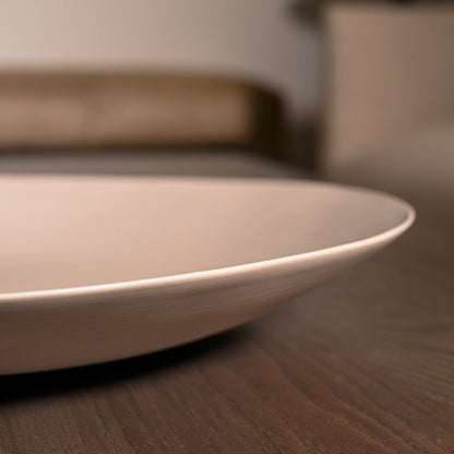 Minimalist shell plate large light brown ceramic with smooth glossy finish and gently curved rim for elegant serving