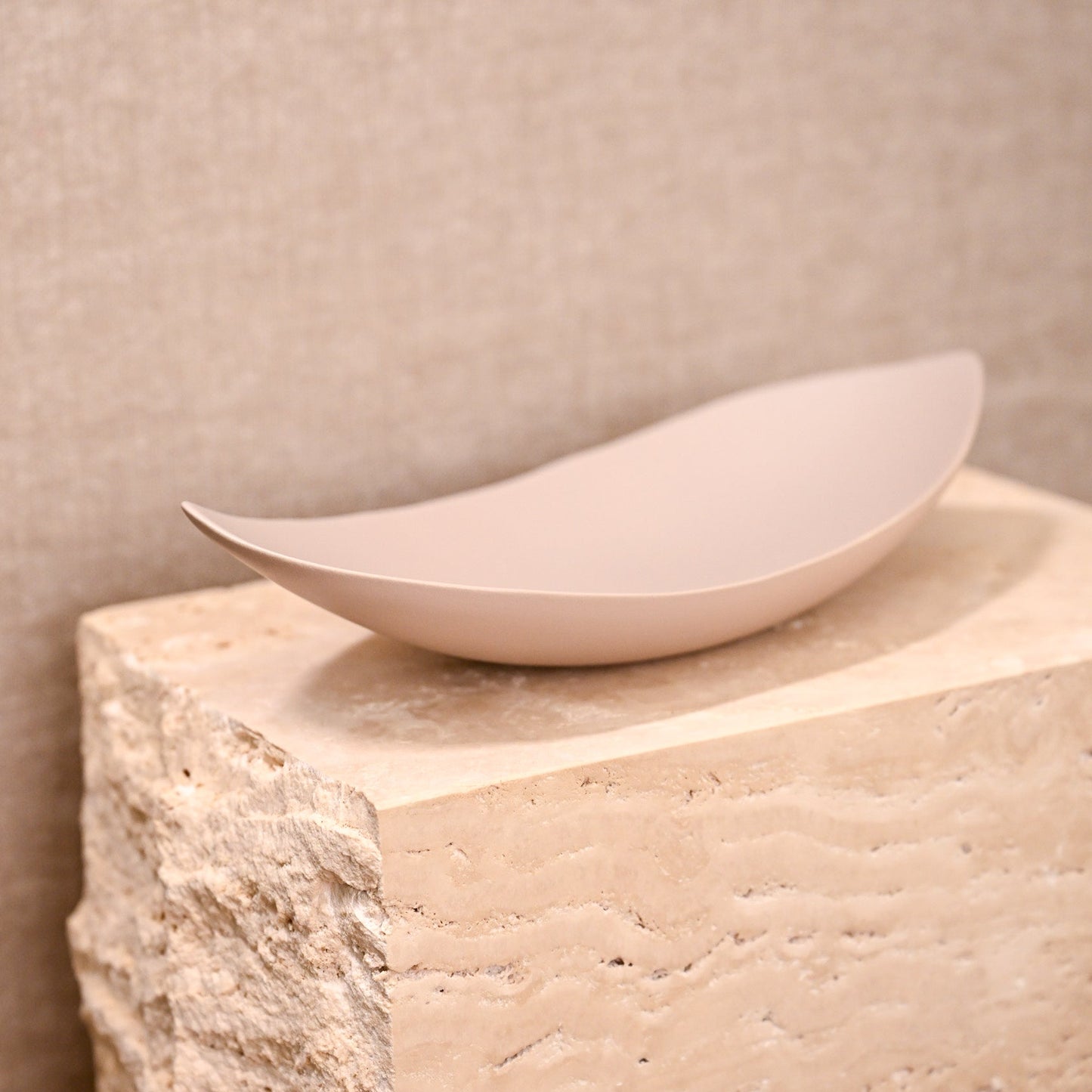 A sleek matte finished off-white ceramic bowl barchetta strette small turtledove with smooth elongated oval shape