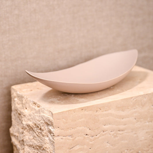 A sleek matte finished off-white ceramic bowl barchetta strette small turtledove with smooth elongated oval shape