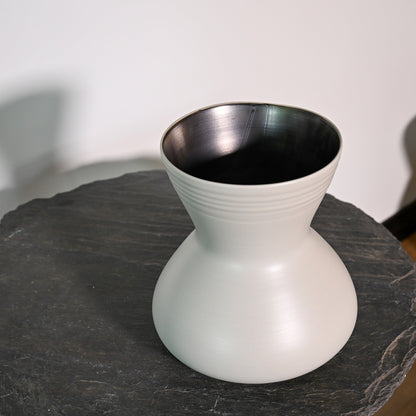 A sleek matte white ceramic giare small linen vase with a flared top and subtle horizontal ridges around its neck