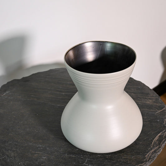A sleek matte white ceramic giare small linen vase with a flared top and subtle horizontal ridges around its neck