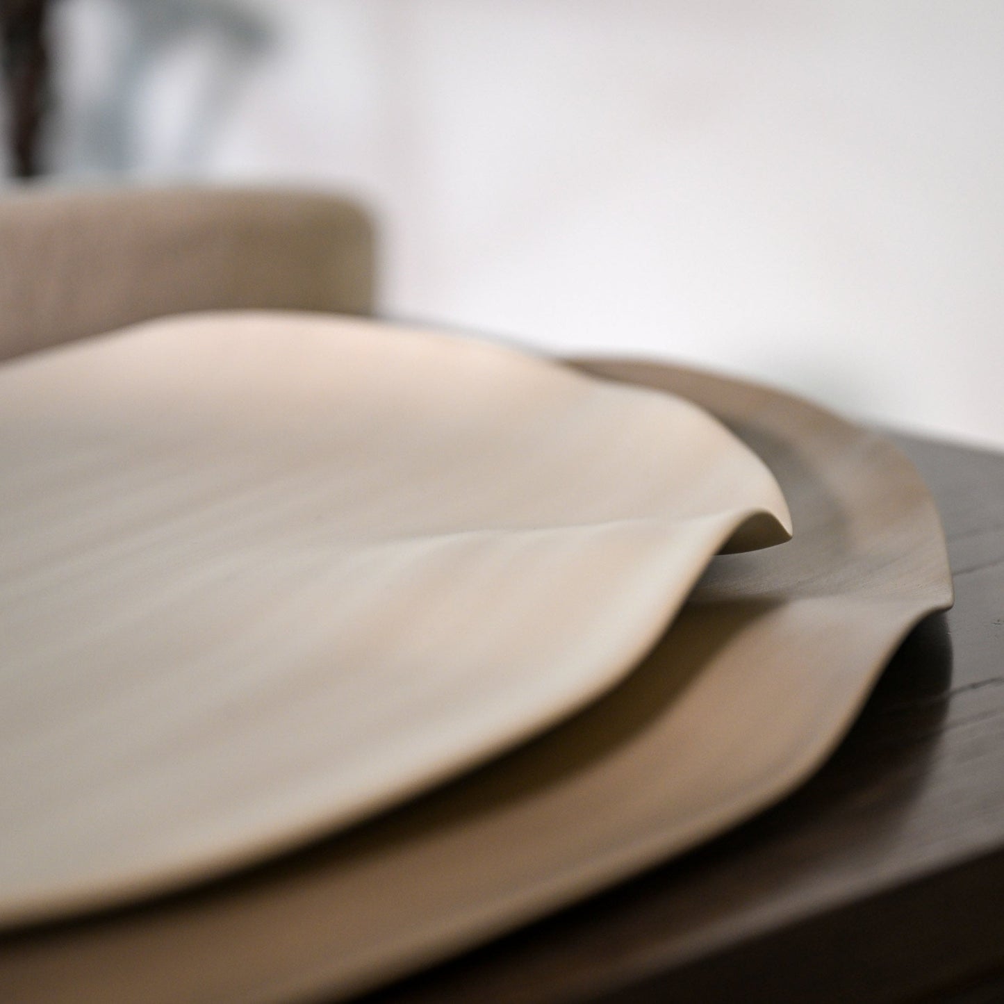 Beige leaf large linen placemats with softly curved edges and a smooth matte finish for dining table use