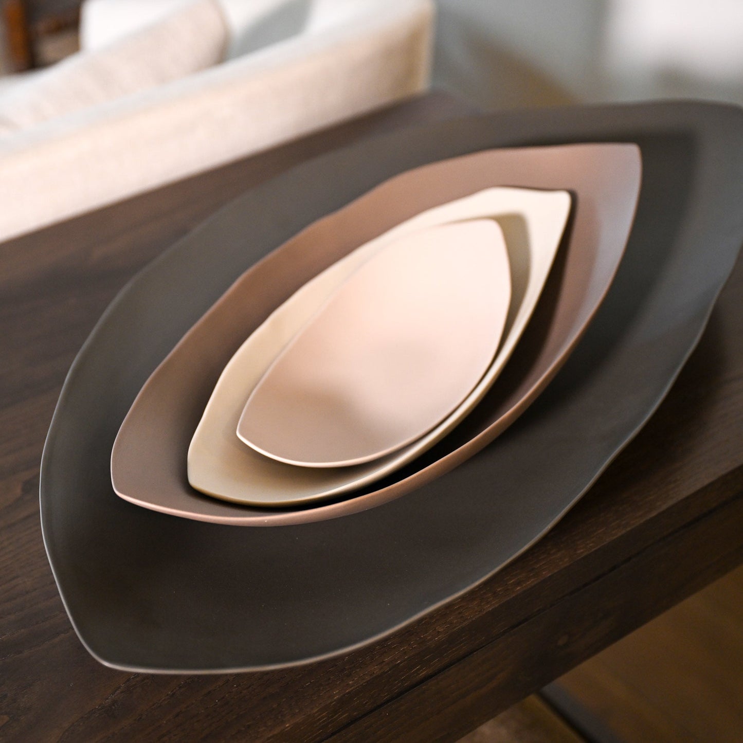 Set of three nested leaf-shaped ceramic serving trays in matte earth tones for serving and decor
