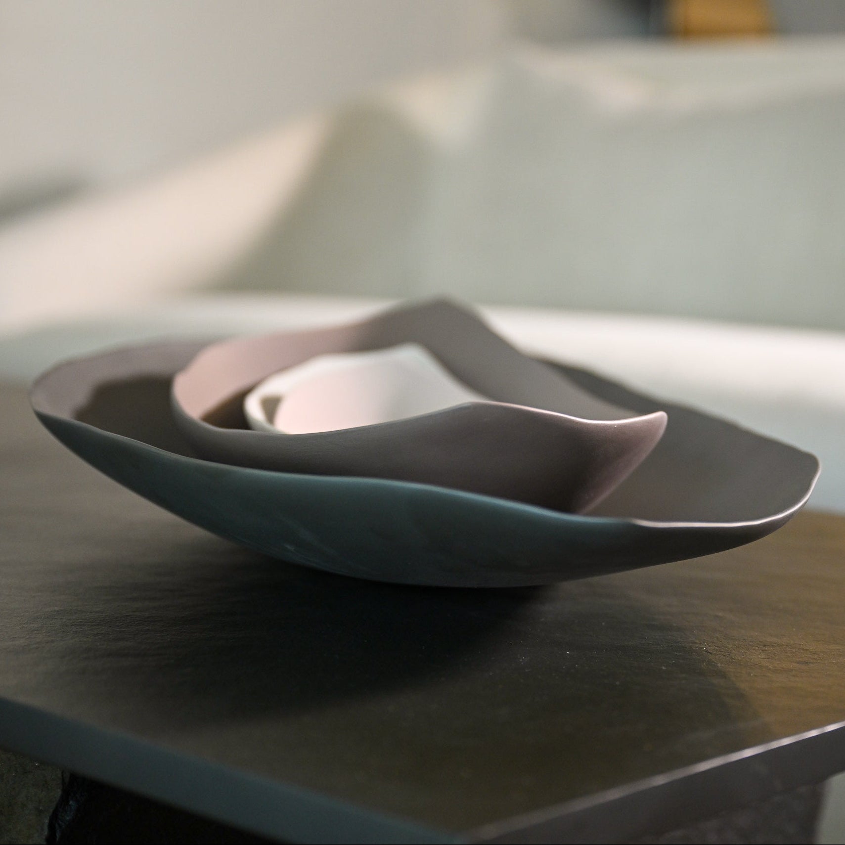 Set of three nested Barchetta Strette Large ceramic bowls in muted teal dusty rose and off-white with matte finishes