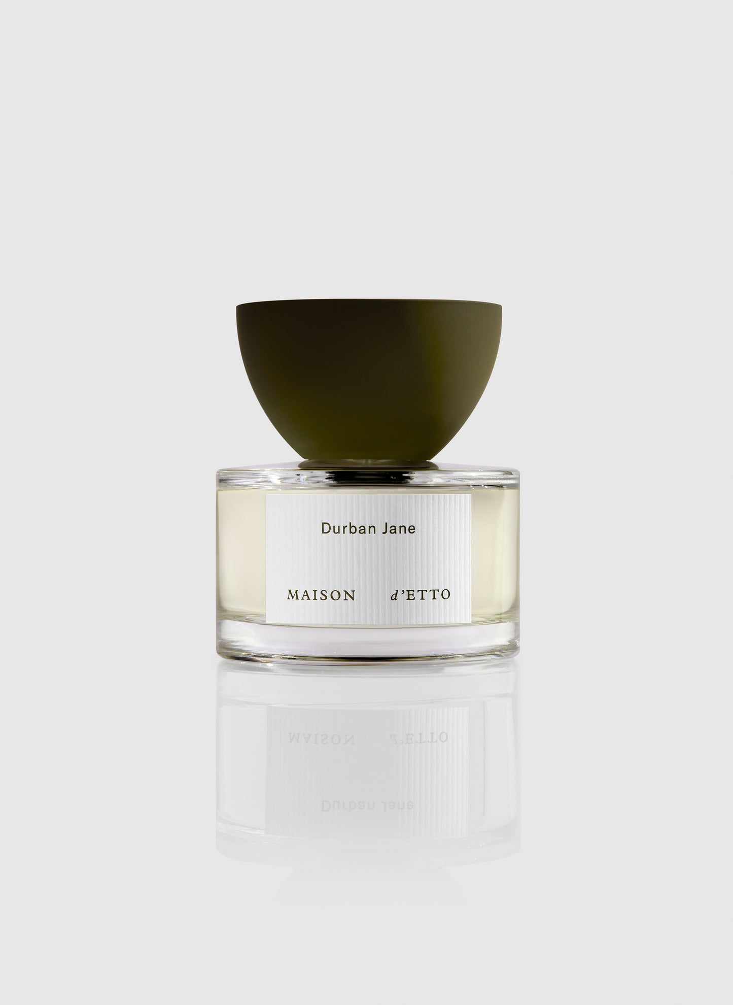 Maison d etto fragrance durban jane perfume in a clear glass bottle with an olive green bowl shaped cap