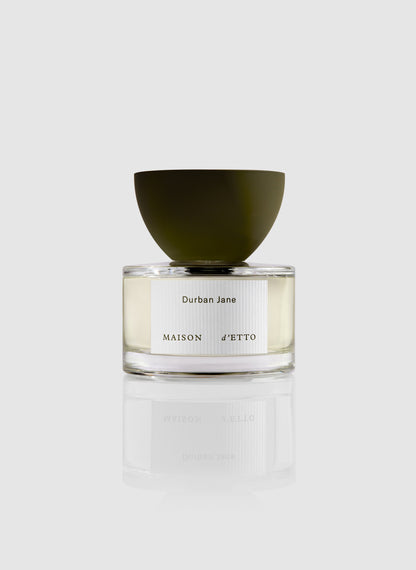 Maison d etto fragrance durban jane perfume in a clear glass bottle with an olive green bowl shaped cap