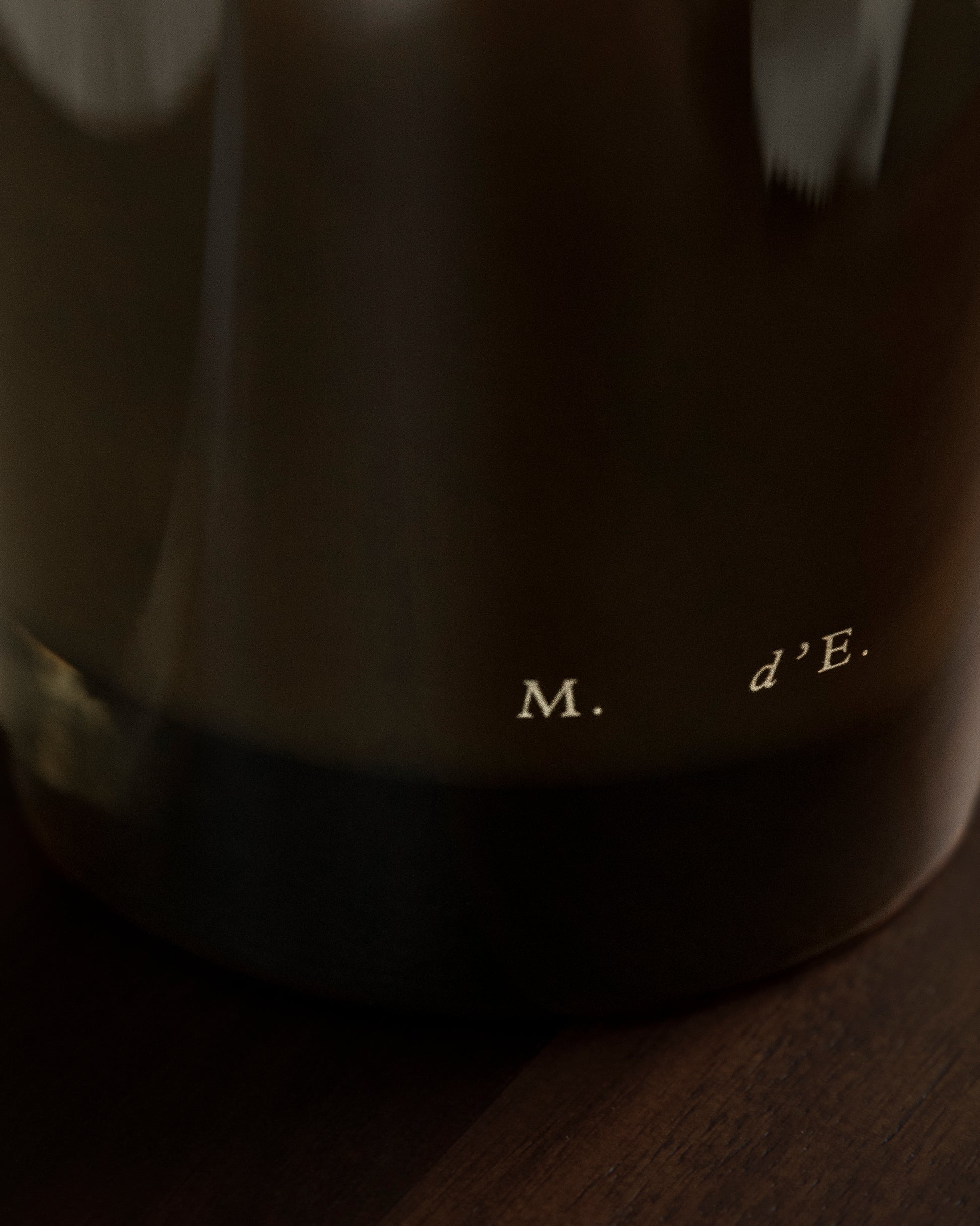 Dark brown ceramic coffee mug with m logo featured with maison detto candle rotano product set
