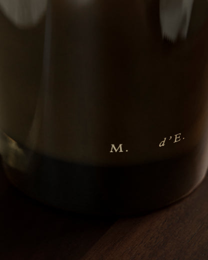 Dark brown ceramic coffee mug with m logo featured with maison detto candle rotano product set