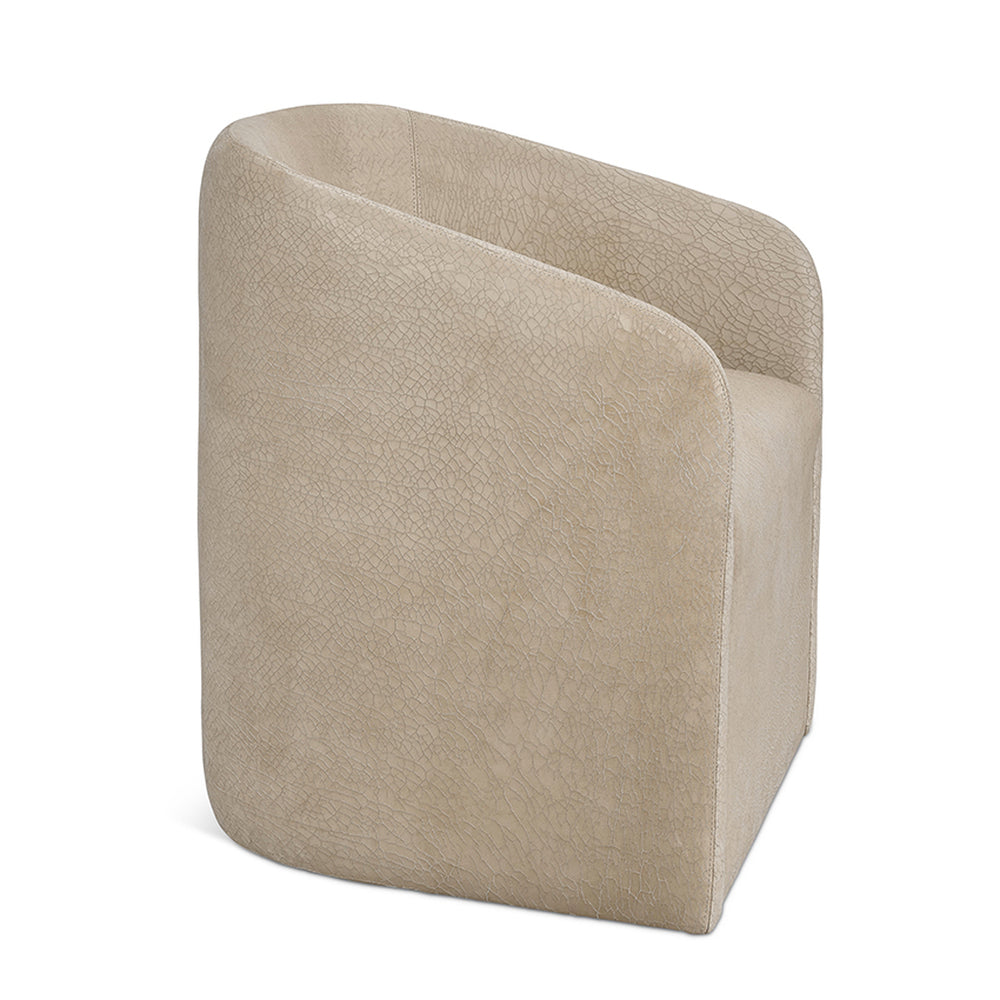 Beige leather Jolene slipcovered swivel bucket chair with textured slightly cracked surface and modern clean lines