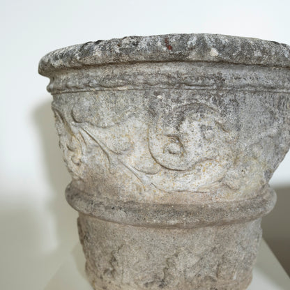 Decorative stone basin with intricate carvings on a white background