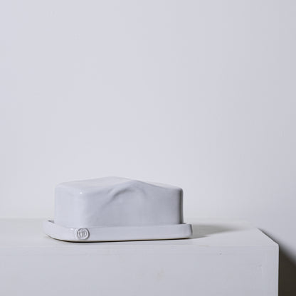 European butter dish no 642 is a white ceramic butter dish with a glossy finish and subtle sculpted ridges on the lid