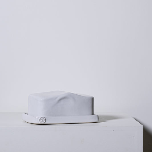 European butter dish no 642 is a white ceramic butter dish with a glossy finish and subtle sculpted ridges on the lid