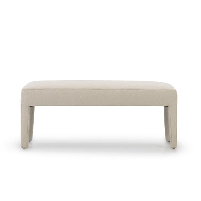 Cream-colored upholstered custom order Charlie bench with clean minimalist lines and tapered legs