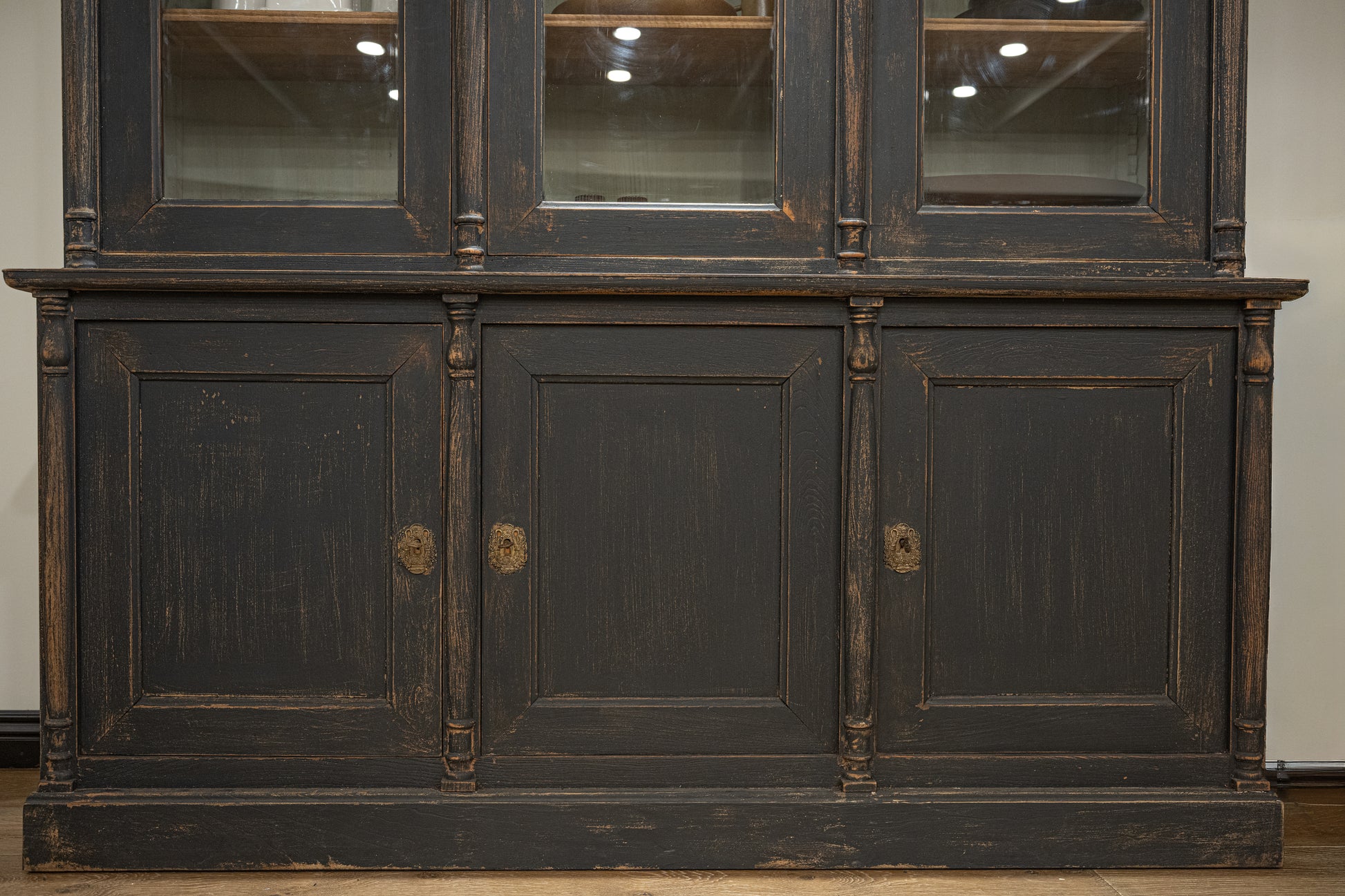 Late 19th century french display cabinet in dark gray distressed wood with glass upper section and brass oval handles