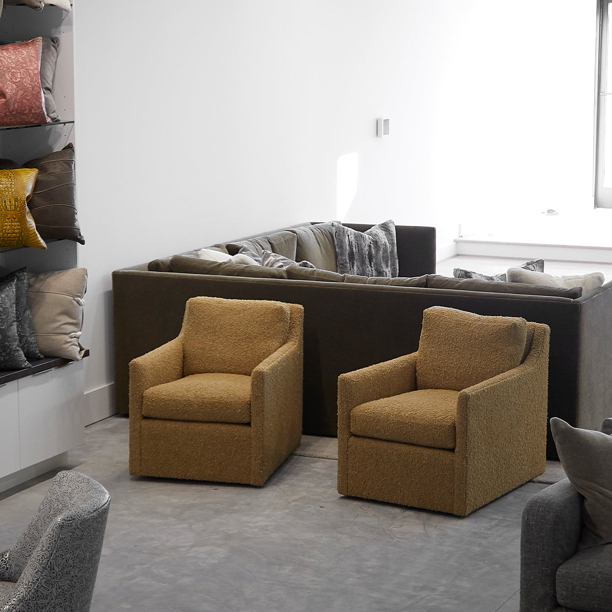 Pair of custom order carmel swivel chairs in mustard yellow plush fabric with square frames for comfortable seating