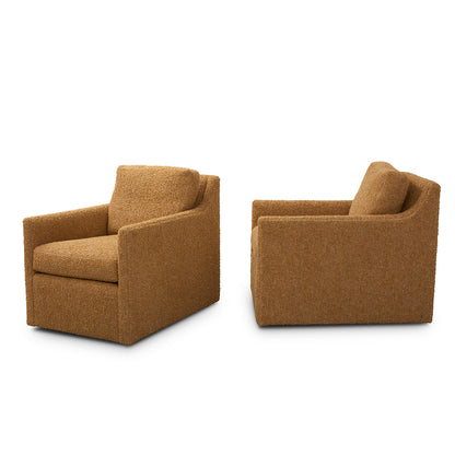 Two tan plush upholstered custom order carmel swivel chairs with modern boxy design