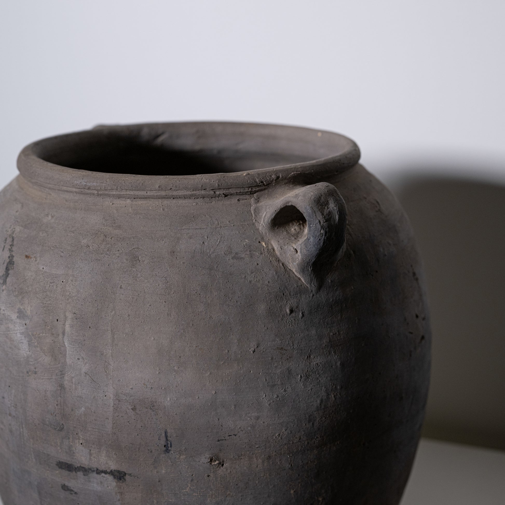 A close-up of a 19th Century Central European Clay Pot with a small handle near the rim, set against a plain background—an ideal antique decor item or vintage collectible for enthusiasts.