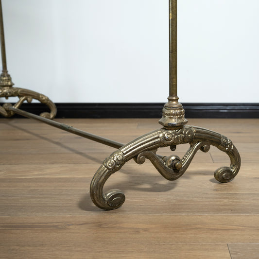 Decorative metal rack with intricate designs on a wooden floor.
