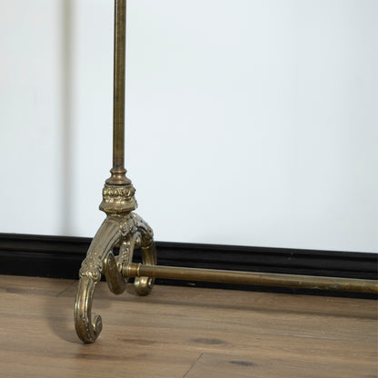 Decorative metal stand on a wooden floor with a white wall background