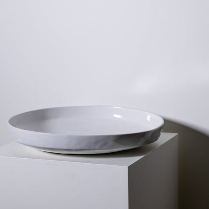 A minimalist white ceramic cottonwood platter no 316 with a smooth glossy finish and subtle textured rim