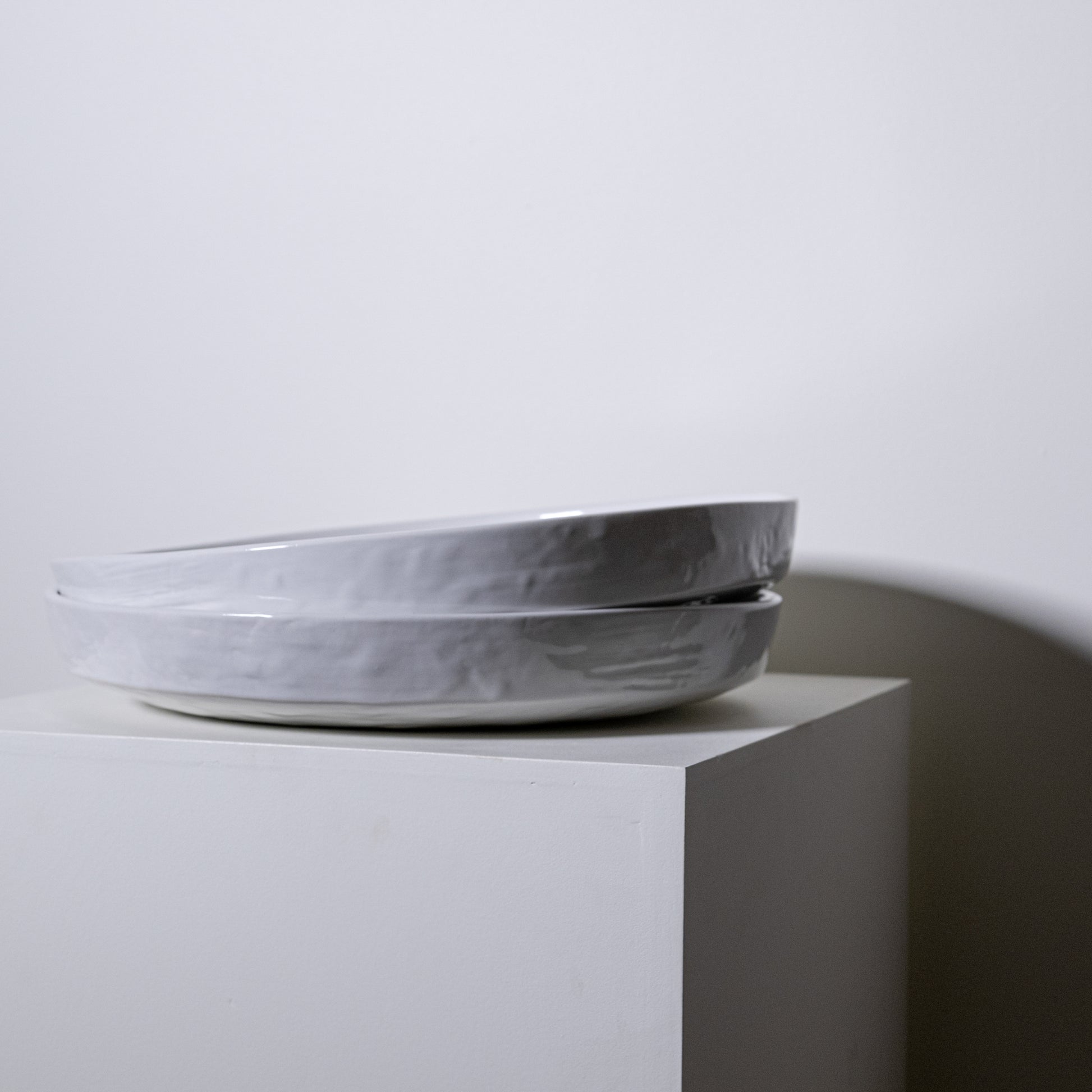 Two stacked matte-finished ceramic cottonwood platter no 316 with subtle texture and soft gray color