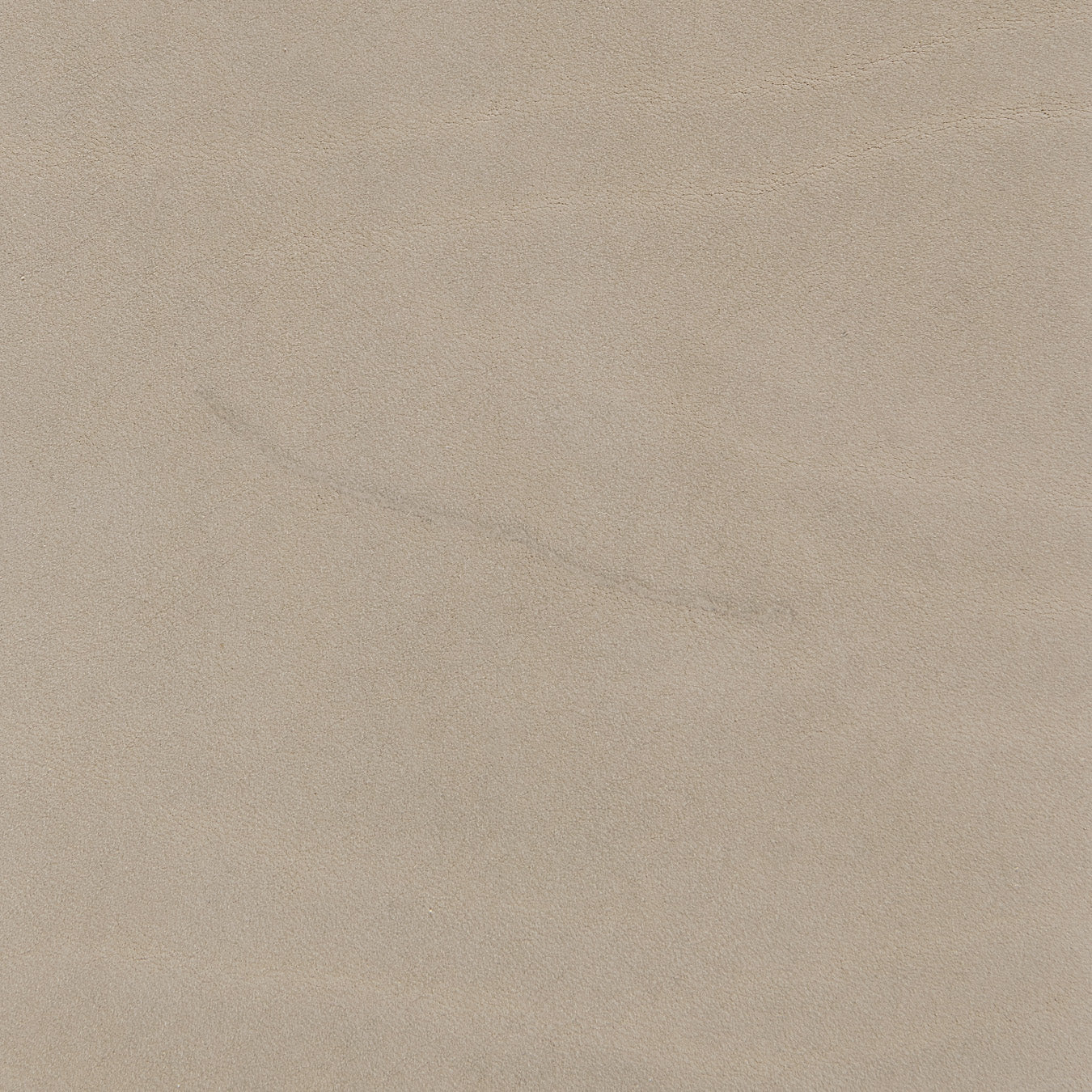 Beige suede fabric with a subtle, natural texture and faint crease.