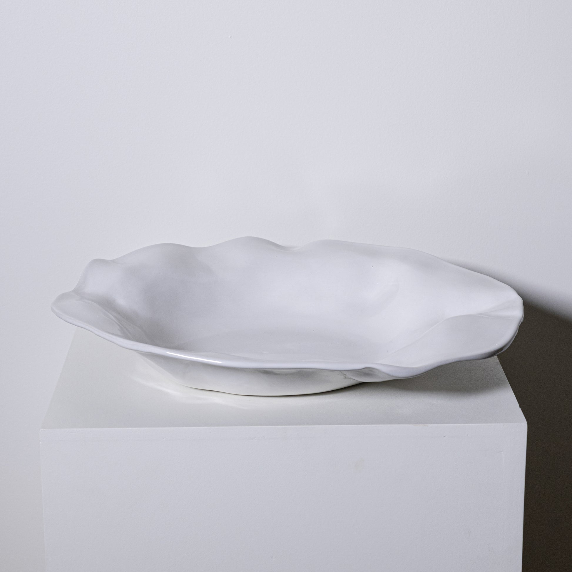A white ceramic Cyprus platter no 724 with a smooth glossy finish and an organic wavy rim