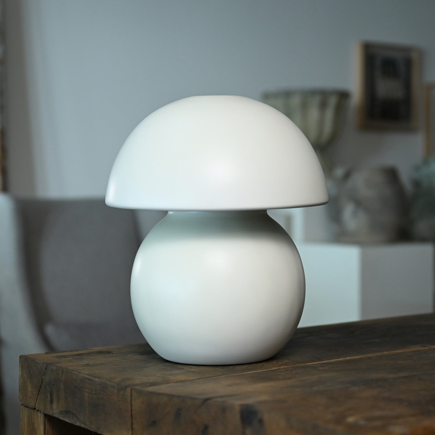 A sleek minimalist white ceramic porcelain luna mushroom shaped table lamp floor model with smooth finish