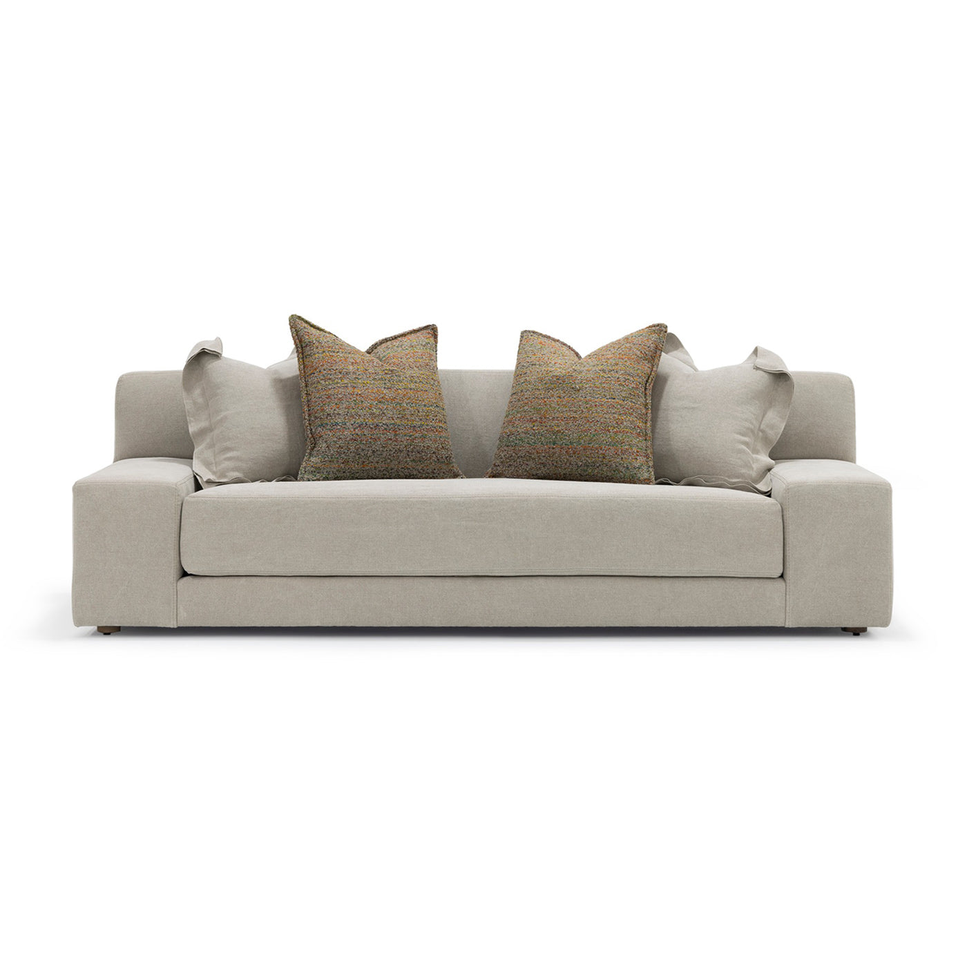 Beige upholstered custom order Esme sofa with two textured brown throw pillows and matching light gray accent cushions