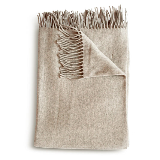 Beige cashmere throw blanket in muslin with soft textured woolen weave and matching fringed edges