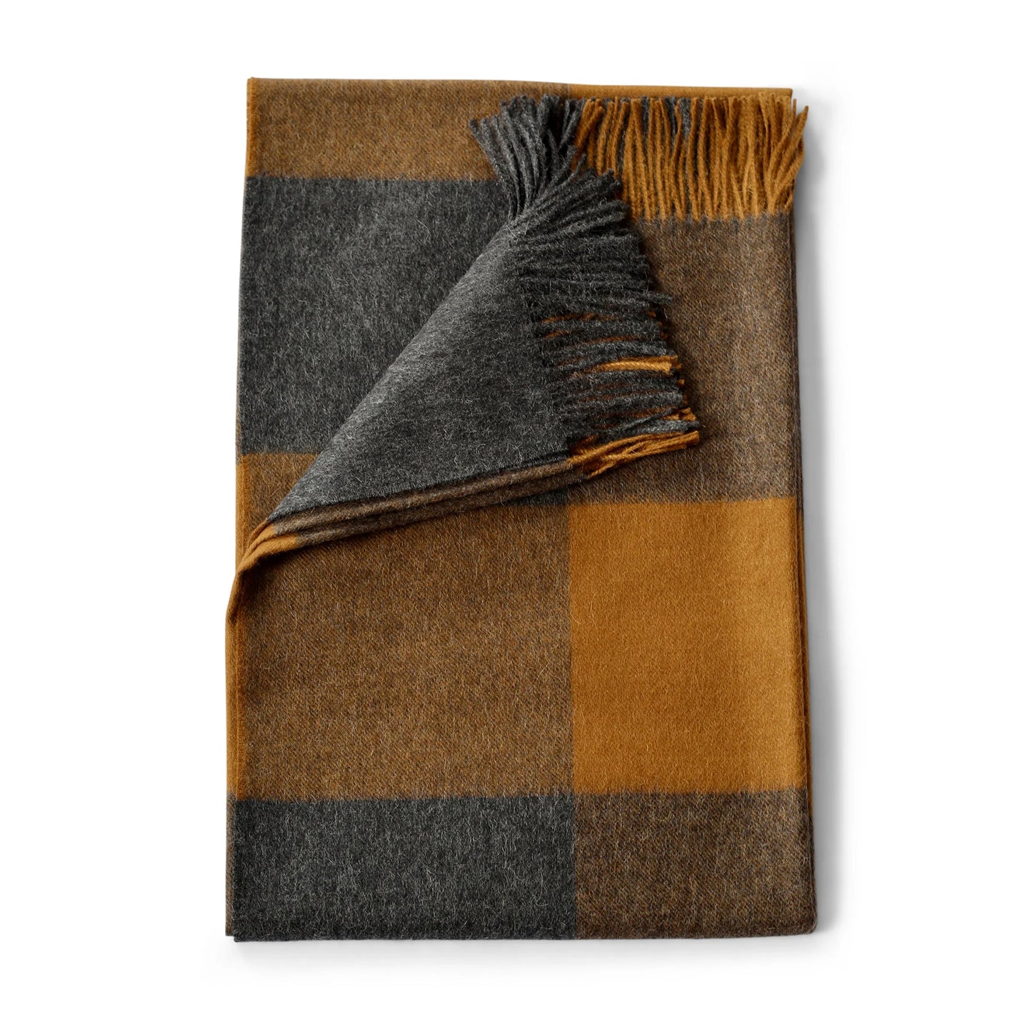 Alpaca plaid throw in amber and ledge with a cozy woven texture and soft fringed edges