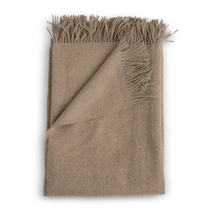 Beige alpaca throw blanket with soft textured weave and fringed edges in fawn color for cozy warmth