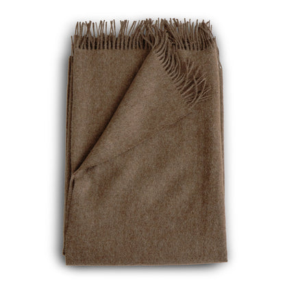 A soft earthy brown alpaca throw in mocha with a textured wool weave and fringed edges