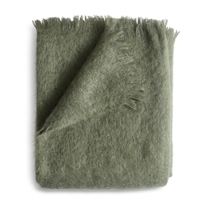 A soft olive green mohair throw blanket with a plush fuzzy texture and fringed edges in moss color